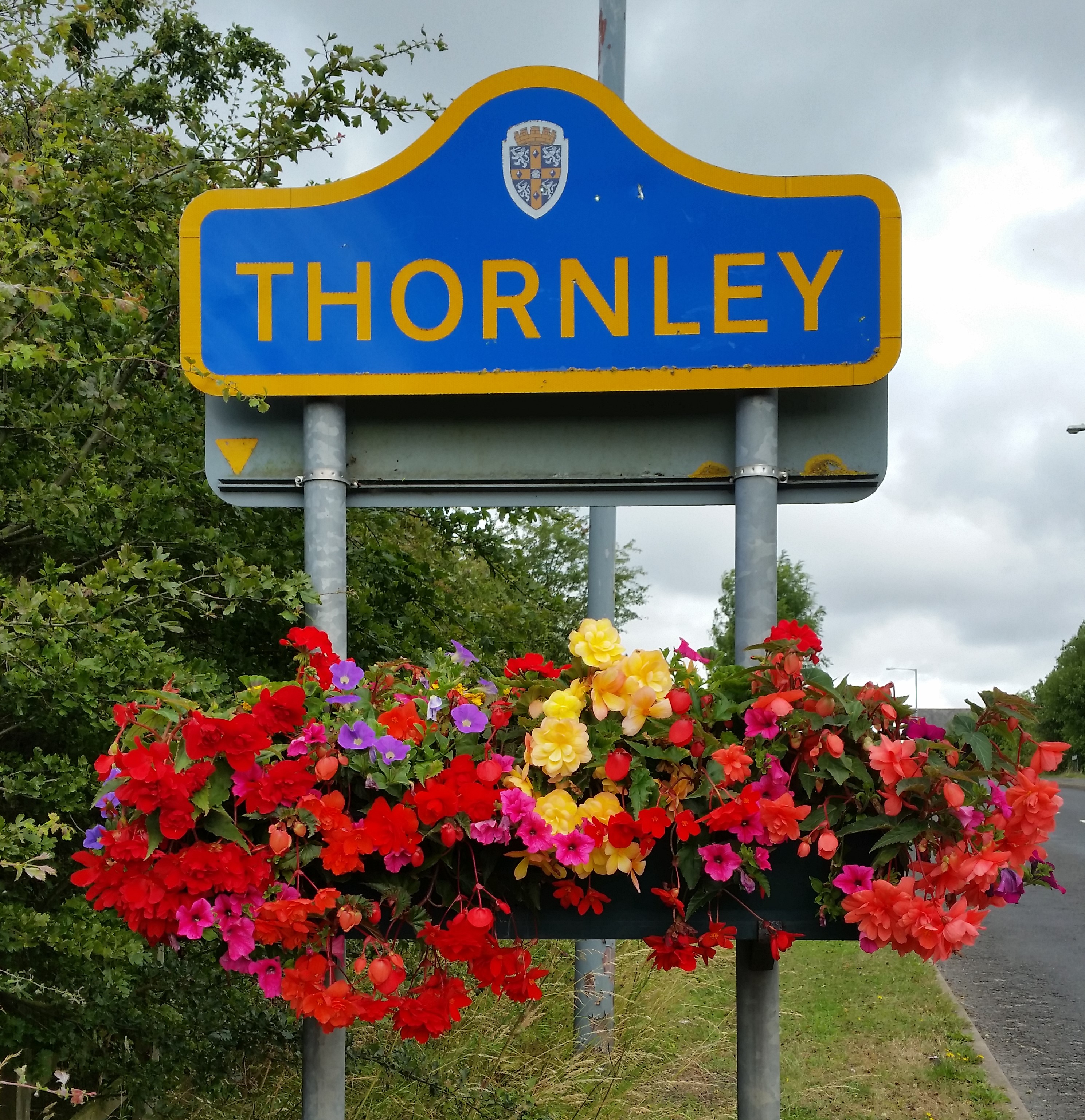 photo of Thornley village entrance sign with floral display